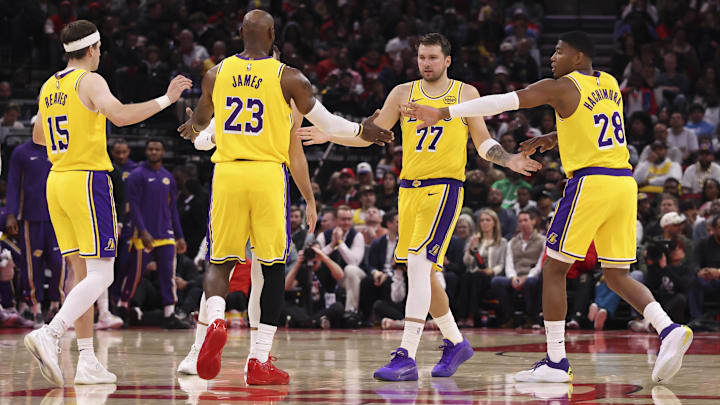 Mar 16, 2026; Houston, Texas, USA; Los Angeles Lakers guard Luka Doncic (77) and forward LeBron James (23) celebrate with teammates after a play during the third quarter against the Houston Rockets at Toyota Center. Mandatory Credit: Troy Taormina-Imagn Images