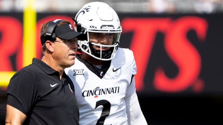 Cincinnati Bearcats head coach Scott Satterfield speaks to Cincinnati Bearcats quarterback Brendan Sorsby (2) in the second quarter of the College Football game between the Cincinnati Bearcats and the Towson Tigers at Nippert Stadium in Cincinnati on Saturday, Aug. 31, 2024. Cincinnati Bearcats head coach Scott Satterfield speaks to Cincinnati Bearcats quarterback Brendan Sorsby (2) in the second quarter of the College Football game between the Cincinnati Bearcats and the Towson Tigers at Nippert Stadium in Cincinnati on Saturday, Aug. 31, 2024.