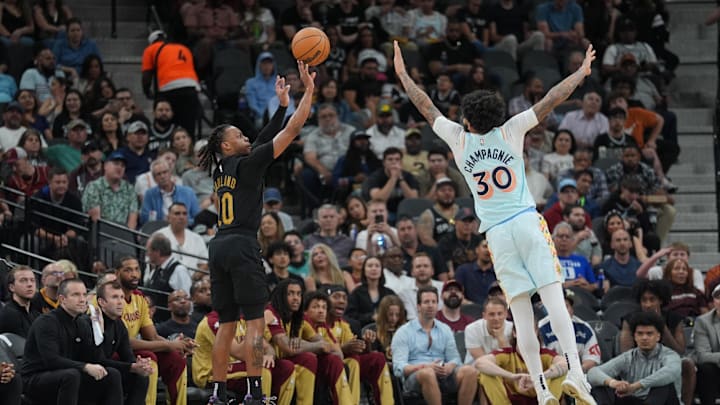 Apr 4, 2025; San Antonio, Texas, USA;  Cleveland Cavaliers guard Darius Garland (10) shoots over San Antonio Spurs forward Julian Champagnie (30) in the second half at Frost Bank Center. Mandatory Credit: Daniel Dunn-Imagn Images