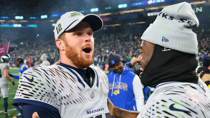 Dec 18, 2025; Seattle, Washington, USA; Seattle Seahawks quarterback Sam Darnold (14) and quarterback Jalen Milroe (6) celebrate after defeating the Los Angeles Rams in overtime at Lumen Field.