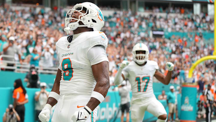 Nov 17, 2024; Miami Gardens, Florida, USA; Miami Dolphins tight end Jonnu Smith (9) celebrates a touchdown against the Las Vegas Raiders in the first quarter at Hard Rock Stadium. Mandatory Credit: Jim Rassol-Imagn Images