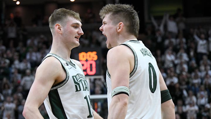 Feb 8, 2025; East Lansing, Michigan, USA; Michigan State Spartans forward Jaxon Kohler (0) and Michigan State Spartans center Carson Cooper (15) celebrate during the second half at Jack Breslin Student Events Center. Mandatory Credit: Dale Young-Imagn Images