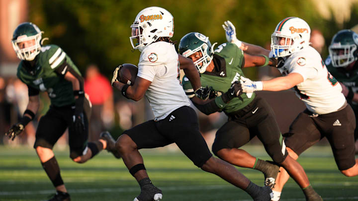Frederick Douglass High School's Dakari Talbert (6) tries to run against the Trinity defense during KHSAA Class 6A football Friday, August 29, 2025 at R.W. Marshall Stadium in Louisville, Kentucky.