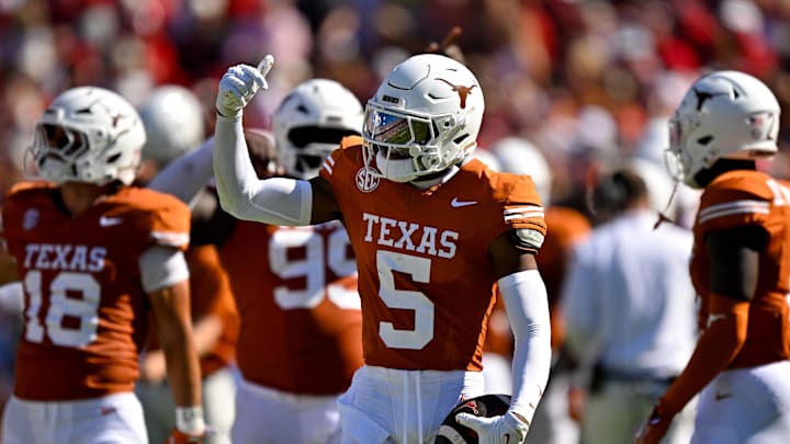 Oct 11, 2025; Dallas, Texas, USA; Texas Longhorns defensive back Malik Muhammad (5) celebrates after he intercepts a pass thrown by Oklahoma Sooners quarterback John Mateer (not pictured) during the first half at the Cotton Bowl. Mandatory Credit: Jerome Miron-Imagn Images