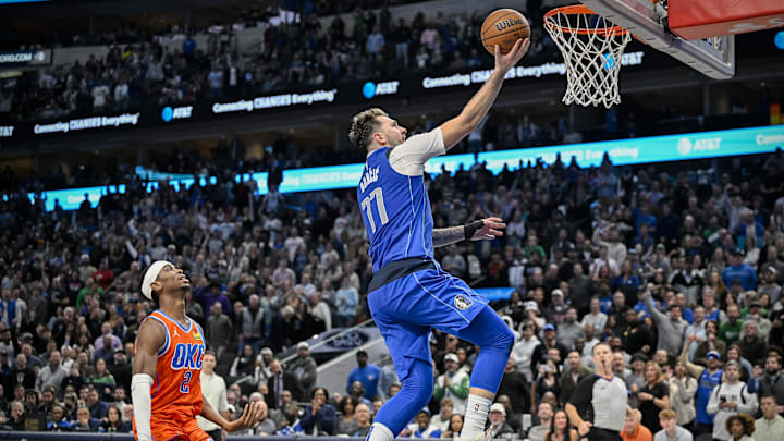 Dec 2, 2023; Dallas, Texas, USA; Dallas Mavericks guard Luka Doncic (77) drives to the basket past Oklahoma City Thunder guard Shai Gilgeous-Alexander (2)