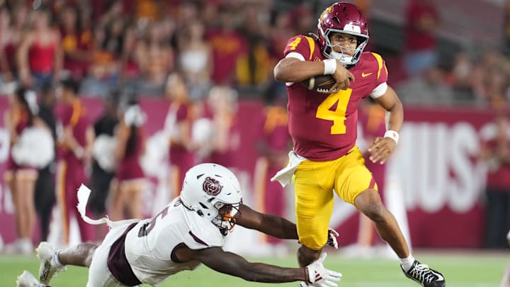 Aug 30, 2025; Los Angeles, California, USA; Southern California Trojans quarterback Husan Longstreet (4) carries the ball against Missouri State Bears cornerback Navonn Barrett (5) in the second half at United Airlines Field at Los Angeles Memorial Coliseum. Mandatory Credit: Kirby Lee-Imagn Images Aug 30, 2025; Los Angeles, California, USA; Southern California Trojans quarterback Husan Longstreet (4) carries the ball against Missouri State Bears cornerback Navonn Barrett (5) in the second half at United Airlines Field at Los Angeles Memorial Coliseum. Mandatory Credit: Kirby Lee-Imagn Images