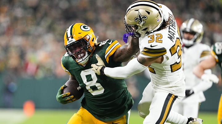 Green Bay Packers running back Josh Jacobs (8) stiff arms New Orleans Saints safety Tyrann Mathieu (32)
