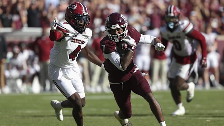 Nov 15, 2025; College Station, Texas, USA; Texas A&M Aggies wide receiver KC Concepcion (7) runs with the ball past South Carolina Gamecocks defensive back Vicari Swain (4) during the fourth quarter at Kyle Field. Mandatory Credit: Troy Taormina-Imagn Images