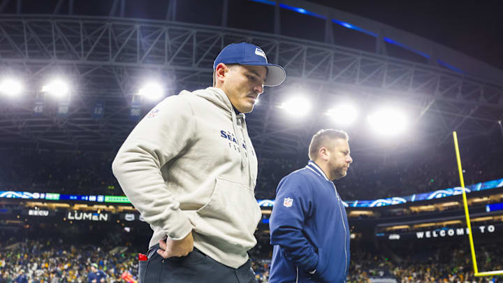 Dec 15, 2024; Seattle, Washington, USA; Seattle Seahawks head coach Mike Macdonald, left, walks to the locker room following a loss against the Green Bay Packers at Lumen Field. Mandatory Credit: Joe Nicholson-Imagn Images