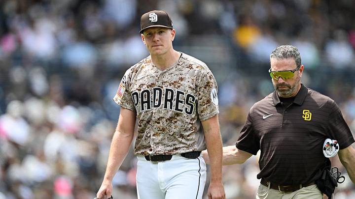 Apr 12, 2026; San Diego, California, USA; San Diego Padres starting pitcher Nick Pivetta (27), left, leaves the field with a trainer during the fourth inning against the Colorado Rockies at Petco Park. Mandatory Credit: Denis Poroy-Imagn Images