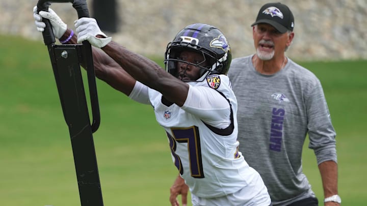 Jul 24, 2025; Owings Mills, MD, USA; Baltimore Ravens coach Chuck Pagano and cornerback Robert Longerbeam (37) work on drills during training camp at the Under Armour Performance Center. Mandatory Credit: Mitch Stringer-Imagn Images