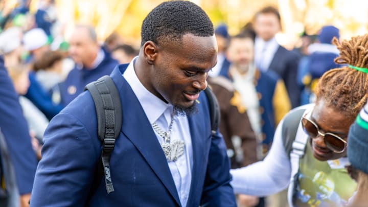 Nov 22, 2025; South Bend, Indiana, USA; Notre Dame Fighting Irish running back Jeremiyah Love greets fans while walking to the stadium before facing the Syracuse Orange at Notre Dame Stadium. Mandatory Credit: Michael Caterina-Imagn Images