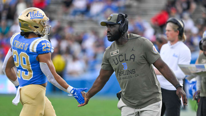 Nov 30, 2024; Pasadena, California, USA; UCLA Bruins head coach DeShaun Foster greets UCLA Bruins running back Anthony Frias II (29) as he returns to the bench during the third quarter against the Fresno State Bulldogs at Rose Bowl. Mandatory Credit: Robert Hanashiro-Imagn Images