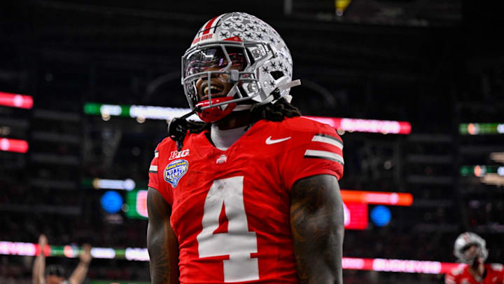 Dec 31, 2025; Arlington, TX, USA; Ohio State Buckeyes wide receiver Jeremiah Smith (4) celebrates after he runs for a touchdown during the 2025 Cotton Bowl and quarterfinal game of the College Football Playoff at AT&T Stadium. Mandatory Credit: Jerome Miron-Imagn Images