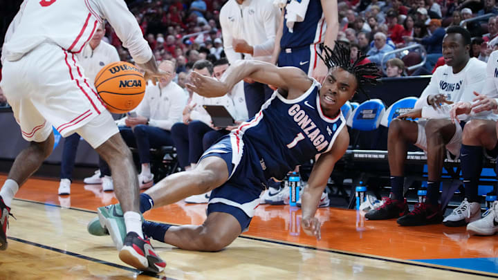 Mar 22, 2025; Wichita, KS, USA; Gonzaga Bulldogs guard Michael Ajayi (1) dives to keep the ball in play against Houston Cougars guard Mylik Wilson (8) during the first half at Intrust Bank Arena. Mandatory Credit: Kirby Lee-Imagn Images