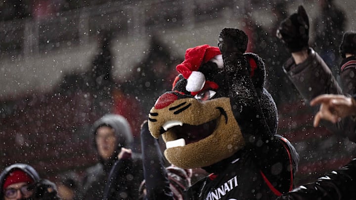 Nov 30, 2024; Cincinnati, Ohio, USA; Cincinnati Bearcats mascots perform in the snow in the fourth quarter of a game against the TCU Horned Frogs at Nippert Stadium. Mandatory Credit: Albert Cesare/USA TODAY Network via Imagn Images