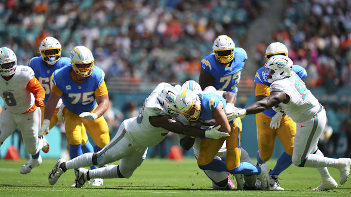 Miami Dolphins defensive tackle Benito Jones (95) tackles Los Angeles Chargers quarterback Justin Herbert (10) during the first quarter at Hard Rock Stadium.