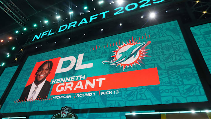 Michigan Wolverines defensive lineman Kenneth Grant is selected as the No. 13 pick by the Miami Dolphins during the NFL Draft at Lambeau Field.
