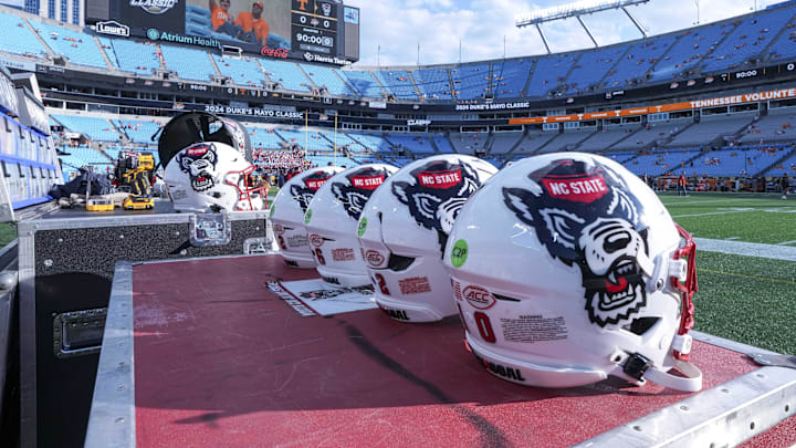 Sep 7, 2024; Charlotte, North Carolina, USA; North Carolina State Wolfpack helmets during pregame activity for the Dukes Mayo Classic against the Tennessee Volunteers at Bank of America Stadium. Mandatory Credit: Jim Dedmon-Imagn Images