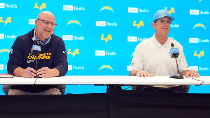 Jan 15, 2026; El Segundo, CA, USA; Los Angeles Chargers general manager Joe Hortiz (left) and coach Jim Harbaugh at press conference at The Bolt. Mandatory Credit: Kirby Lee-Imagn Images