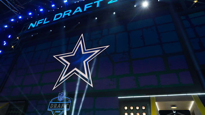 The Dallas Cowboys logo is projected on the video board during the NFL Draft at Lambeau Field. 