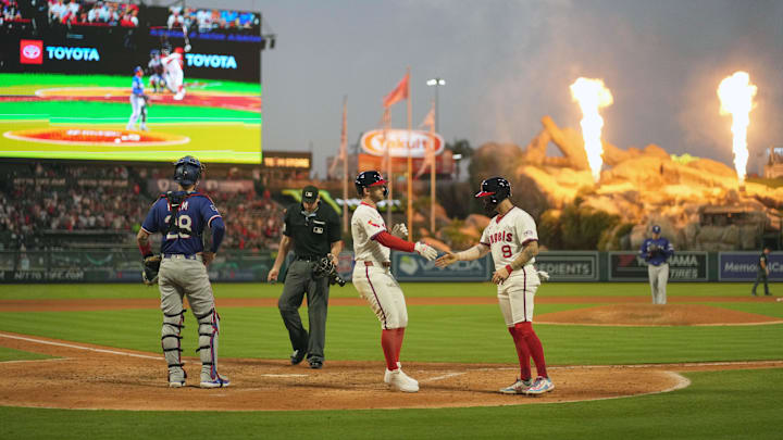 Jul 10, 2025; Anaheim, California, USA; Los Angeles Angels left fielder Taylor Ward (3) is congratulated by shortstop Zach Neto (9) against Texas Rangers starting pitcher Patrick Corbin (46) in the fifth inning as catcher Jonah Heim (28) and home plate umpire Nate Tomlinson watches at Angel Stadium. Mandatory Credit: Kirby Lee-Imagn Images Jul 10, 2025; Anaheim, California, USA; Los Angeles Angels left fielder Taylor Ward (3) is congratulated by shortstop Zach Neto (9) against Texas Rangers starting pitcher Patrick Corbin (46) in the fifth inning as catcher Jonah Heim (28) and home plate umpire Nate Tomlinson watches at Angel Stadium. Mandatory Credit: Kirby Lee-Imagn Images