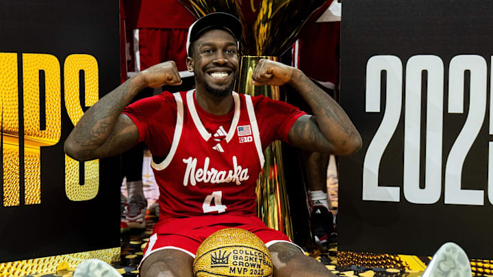 Nebraska forward Juwan Gary sits in front with his MVP ball as the team poses after winning the College Basketball Crown in Las Vegas.