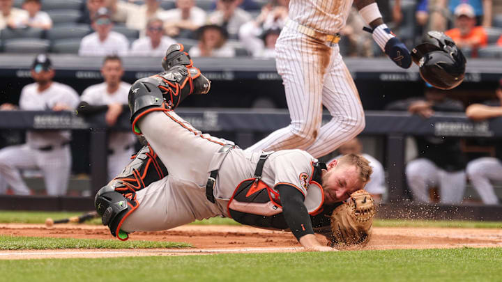 Jun 22, 2025; Bronx, New York, USA; New York Yankees second baseman Jazz Chisholm Jr. (13) collides with Baltimore Orioles catcher Maverick Handley (98) at home plate during the second inning at Yankee Stadium. 