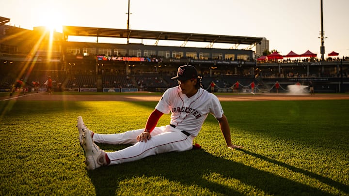 Worcester Red Sox player Roman Anthony stretches on the outfield grass at Polar Park prior to a game on Aug. 27.