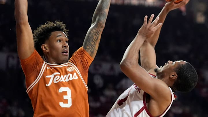 Oklahoma's Xzayvier Brown (1) shoots as Texas' Dailyn Swain (3) defends in the first half of the men's college basketball game between the Oklahoma Sooners and the Texas Longhorns at Lloyd Noble Center in Norman, Okla., Saturday Jan. 31, 2026.