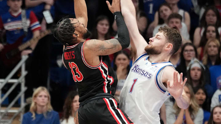 Jan 25, 2025; Lawrence, Kansas, USA; Houston Cougars forward J'Wan Roberts (13) shoots over Kansas Jayhawks center Hunter Dickinson (1) during the second half at Allen Fieldhouse. Mandatory Credit: Denny Medley-Imagn Images