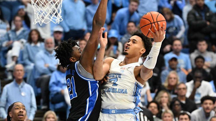 Feb 7, 2026; Chapel Hill, North Carolina, USA;  North Carolina Tar Heels guard Seth Trimble (7) shoots as Duke Blue Devils center Patrick Ngongba (21) defends.