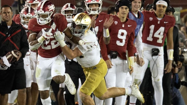 Nov 25, 2023; Stanford, California, USA; Stanford Cardinal running back E.J. Smith (22) cannot escape Notre Dame Fighting Irish linebacker Drayk Bowen (34) during the fourth quarter at Stanford Stadium. Mandatory Credit: D. Ross Cameron-Imagn Images