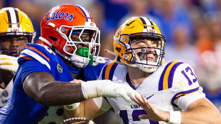 Florida Gators defensive lineman Caleb Banks (88) causes a fumble as he strips the ball from LSU Tigers quarterback Garrett Nussmeier (13) during the second half at Ben Hill Griffin Stadium in Gainesville, FL on Saturday, November 16, 2024. The Gators defeated the Tigers 27-16. [Doug Engle/Gainesville Sun]