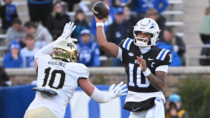 Duke quarterback Darian Mensah (10) throws the ball under pressure from Wake Forest defensive lineman Gabe Kirschke (10)