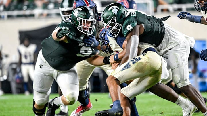 Michigan State's Jalen Thompson, right, tackles Florida Atlantic's Cam Fancher during the fourth quarter on Friday, Aug. 30, 2024, at Spartan Stadium in East Lansing.
