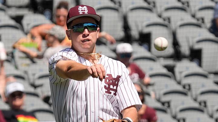 May 21, 2025; Hoover, AL, USA; Mississippi State third baseman Ace Reese (3) fields a bunt by Texas A&M second baseman Ben Royo (10) but makes a wild throw to first in the first round of the SEC Baseball Tournament at the Hoover Met. May 21, 2025; Hoover, AL, USA; Mississippi State third baseman Ace Reese (3) fields a bunt by Texas A&M second baseman Ben Royo (10) but makes a wild throw to first in the first round of the SEC Baseball Tournament at the Hoover Met.