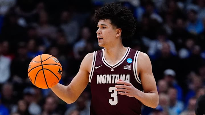 Mar 20, 2025; Denver, CO, USA; Montana Grizzlies guard Malik Moore (3) dribbles the ball against the Wisconsin Badgers during the first half in the first round of the NCAA Tournament at Ball Arena. Mandatory Credit: Ron Chenoy-Imagn Images