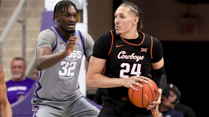 Feb 12, 2025; Fort Worth, Texas, USA;  Oklahoma State Cowboys forward Patrick Suemnick (24) controls the ball as TCU Horned Frogs center Malick Diallo (32) defends during the first half at Ed and Rae Schollmaier Arena. Mandatory Credit: Kevin Jairaj-Imagn Images