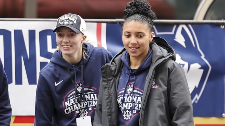 UConn student-athlete Paige Bueckers and UConn student-athlete Azzi Fudd walk onto the stage during the Final Four Champions victory parade and rally outside of the XL Center in Hartford, CT.