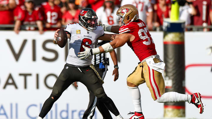 Nov 10, 2024; Tampa, Florida, USA; Tampa Bay Buccaneers quarterback Baker Mayfield (6) holds off San Francisco 49ers defensive end Nick Bosa (97) in the fourth quarter at Raymond James Stadium. Mandatory Credit: Nathan Ray Seebeck-Imagn Images