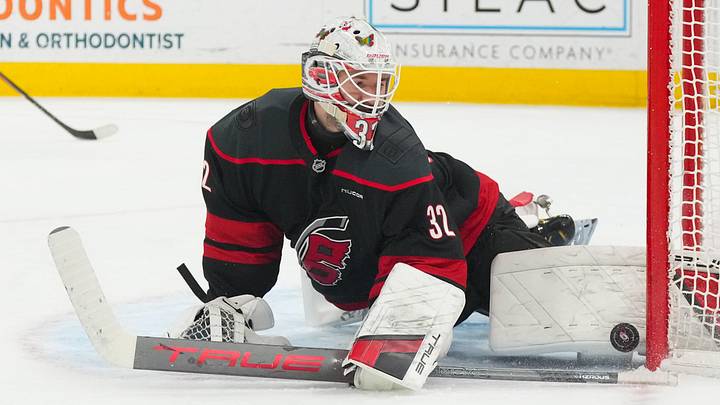 Jan 19, 2026; Raleigh, North Carolina, USA;  Carolina Hurricanes goaltender Brandon Bussi (32) makes a pad save against the Buffalo Sabres during the second period at Lenovo Center. Mandatory Credit: James Guillory-Imagn Images