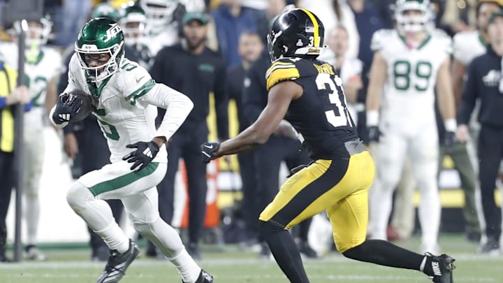 Oct 20, 2024; Pittsburgh, Pennsylvania, USA;  New York Jets wide receiver Garrett Wilson (5) runs after a catch against the Pittsburgh Steelers during the fourth quarter at Acrisure Stadium. 