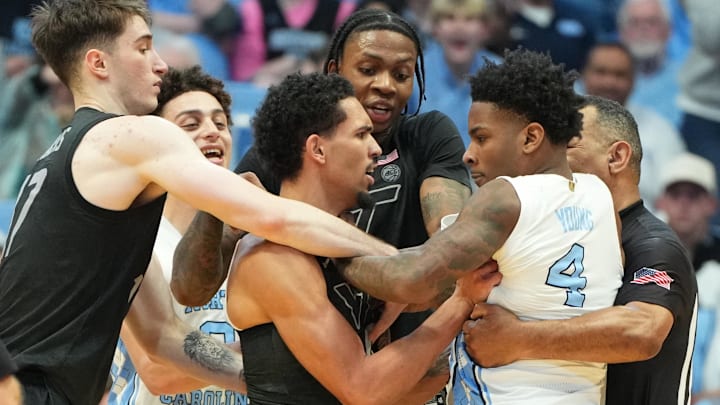 Feb 28, 2026; Chapel Hill, N.C.; North Carolina guard Jaydon Young (4) and Virginia Tech guard Jailen Bedford (0) argue as VT guard Neoklis Avdalas (17) and forward Tobi Lawal (1) try to step in
