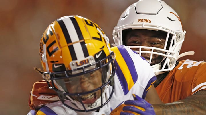 Sep 7, 2019; Austin, TX, USA; LSU Tigers wide receiver Justin Jefferson (2) catches a touchdown as Texas Longhorns defensive back Josh Thompson (29) tries to defend in the first half at Darrell K Royal-Texas Memorial Stadium. Mandatory Credit: Ronald Cortes-Imagn Images