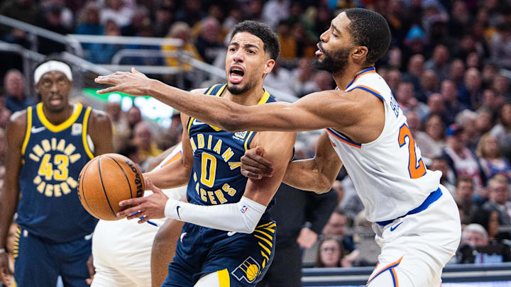Feb 11, 2025; Indianapolis, Indiana, USA; Indiana Pacers guard Tyrese Haliburton (0) shoots the ball while New York Knicks forward Mikal Bridges (25) defends in the first half at Gainbridge Fieldhouse. Mandatory Credit: Trevor Ruszkowski-Imagn Images Feb 11, 2025; Indianapolis, Indiana, USA; Indiana Pacers guard Tyrese Haliburton (0) shoots the ball while New York Knicks forward Mikal Bridges (25) defends in the first half at Gainbridge Fieldhouse. Mandatory Credit: Trevor Ruszkowski-Imagn Images
