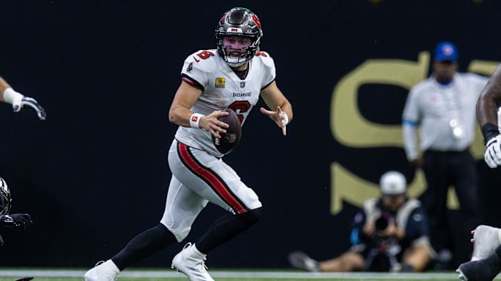 Oct 13, 2024; New Orleans, Louisiana, USA;  Tampa Bay Buccaneers quarterback Baker Mayfield (6) scrambles out the pocket against the New Orleans Saints during the second half at Caesars Superdome. Mandatory Credit: Stephen Lew-Imagn Images