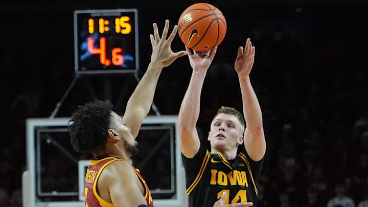 Iowa Hawkeyes guard Bennett Stirtz (14) takes a three-point shot over Iowa State Cyclones forward Joshua Jefferson (5) during the first half in the men’s basketball Cy-Hawk series on Dec. 11, 2025, in Ames, Iowa. Iowa Hawkeyes guard Bennett Stirtz (14) takes a three-point shot over Iowa State Cyclones forward Joshua Jefferson (5) during the first half in the men’s basketball Cy-Hawk series on Dec. 11, 2025, in Ames, Iowa.