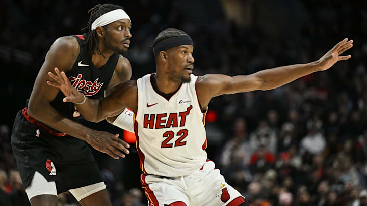 Feb 27, 2024; Portland, Oregon, USA; Miami Heat forward Jimmy Butler (22) reaches for a pass during the second half against Portland Trail Blazers forward Jerami Grant (9) at Moda Center. Mandatory Credit: Troy Wayrynen-Imagn Images
