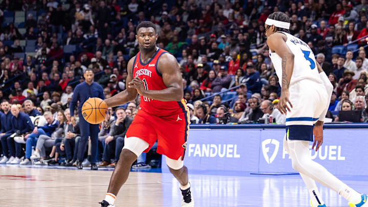 Dec 11, 2023; New Orleans, Louisiana, USA; New Orleans Pelicans forward Zion Williamson (1) dribbles against Minnesota Timberwolves forward Jaden McDaniels (3) during the second half at the Smoothie King Center. Mandatory Credit: Stephen Lew-Imagn Images